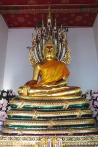 Buddha with the naga (multi-headed snake) behind him